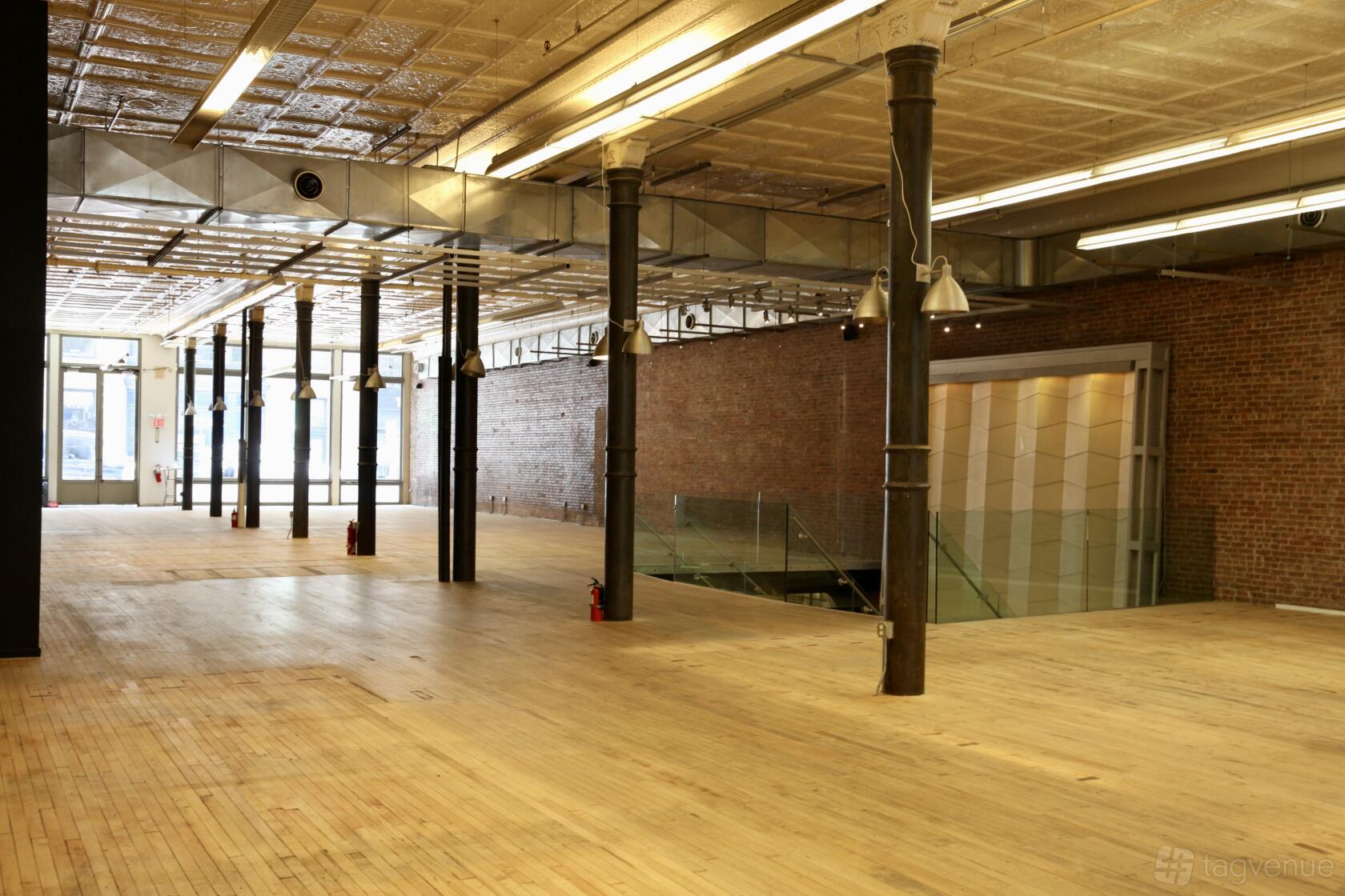 An event venue with exposed brick walls, high ceilings, and hardwood floors at Soholofts.nyc.