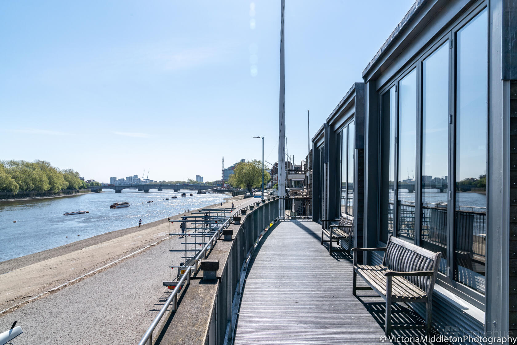 A versatile event space with a riverside balcony, bench seating, and views of the Thames at Thames Rowing Club.