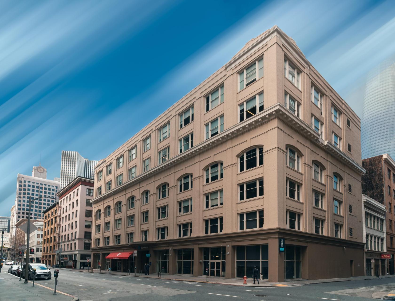 A meeting centre with large corner windows and beige stone facade at Werqwise San Francisco.