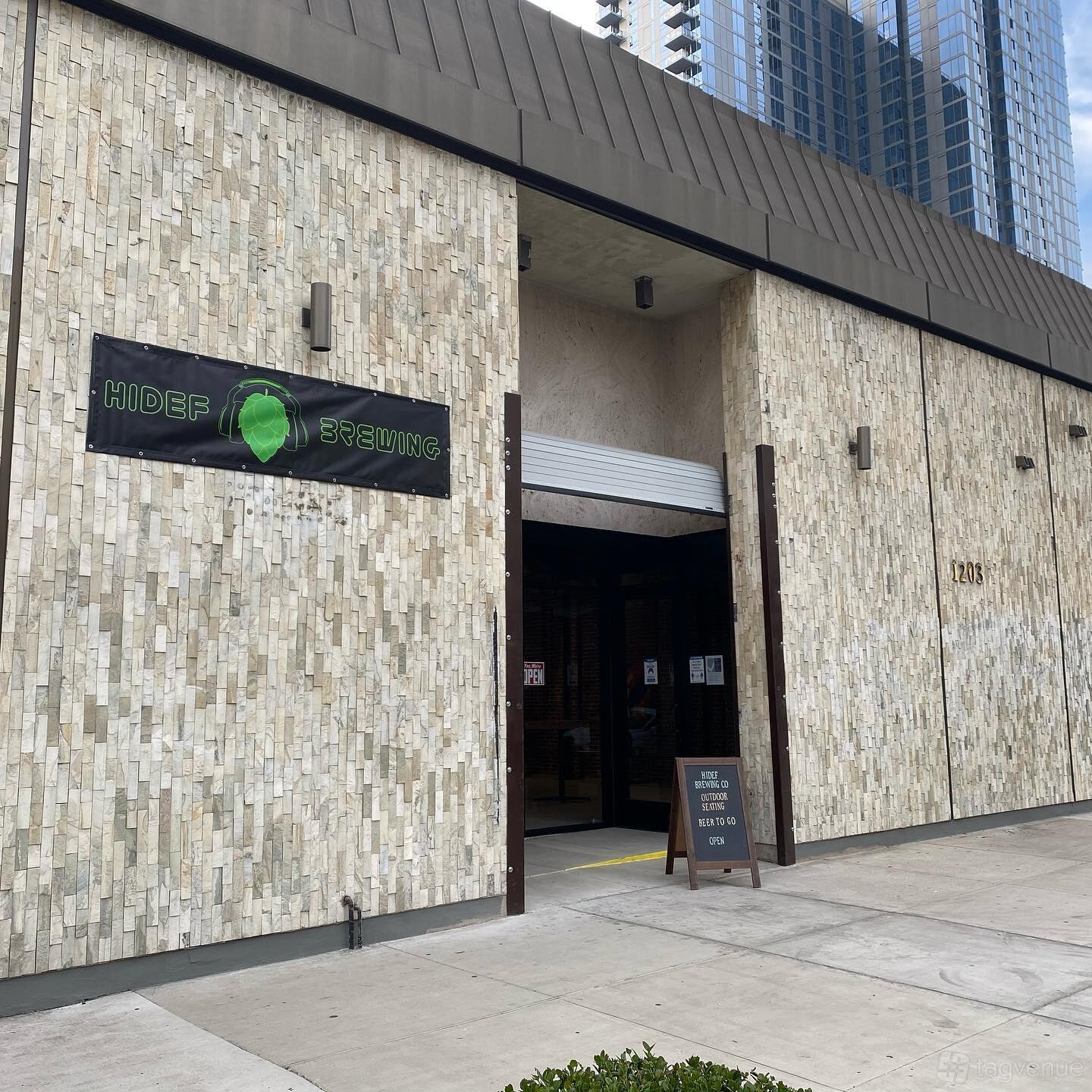 A versatile event space with a stone facade and garage-style entrance at HiDef Brewing Co.
