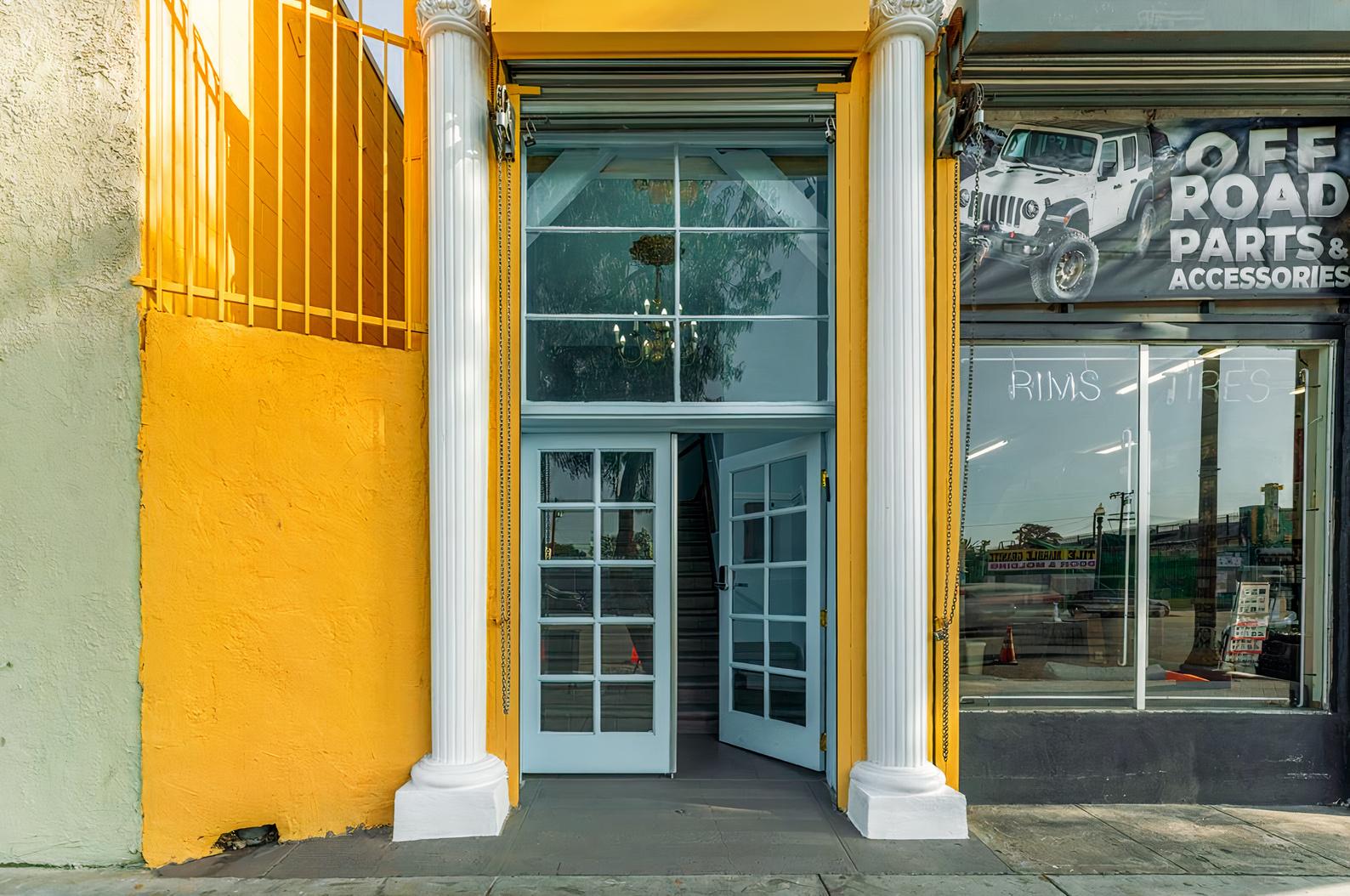 A historic building with tall white columns and a large glass entrance at Grand Lodge of LA.
