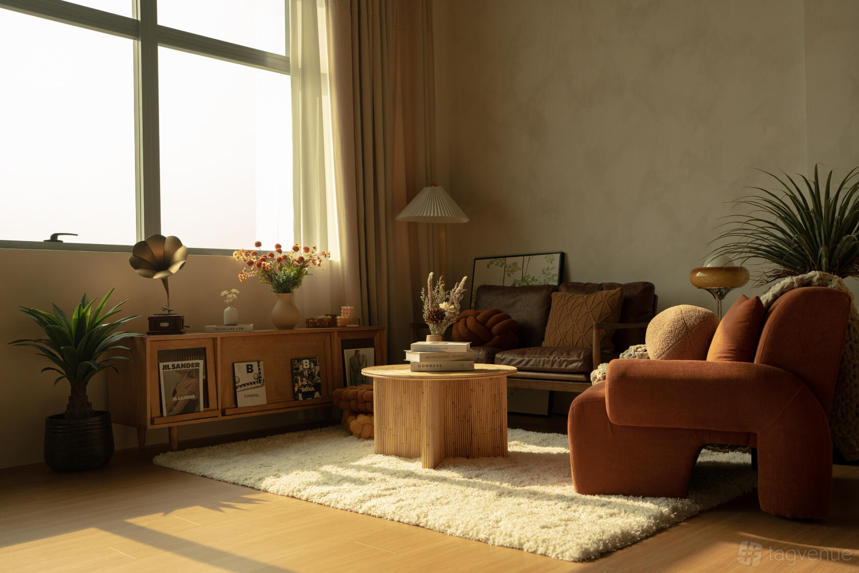A photo studio with a cozy lounge area, large window, warm-toned furniture, and indoor plants at Cloud Studio by The Studio Clan.