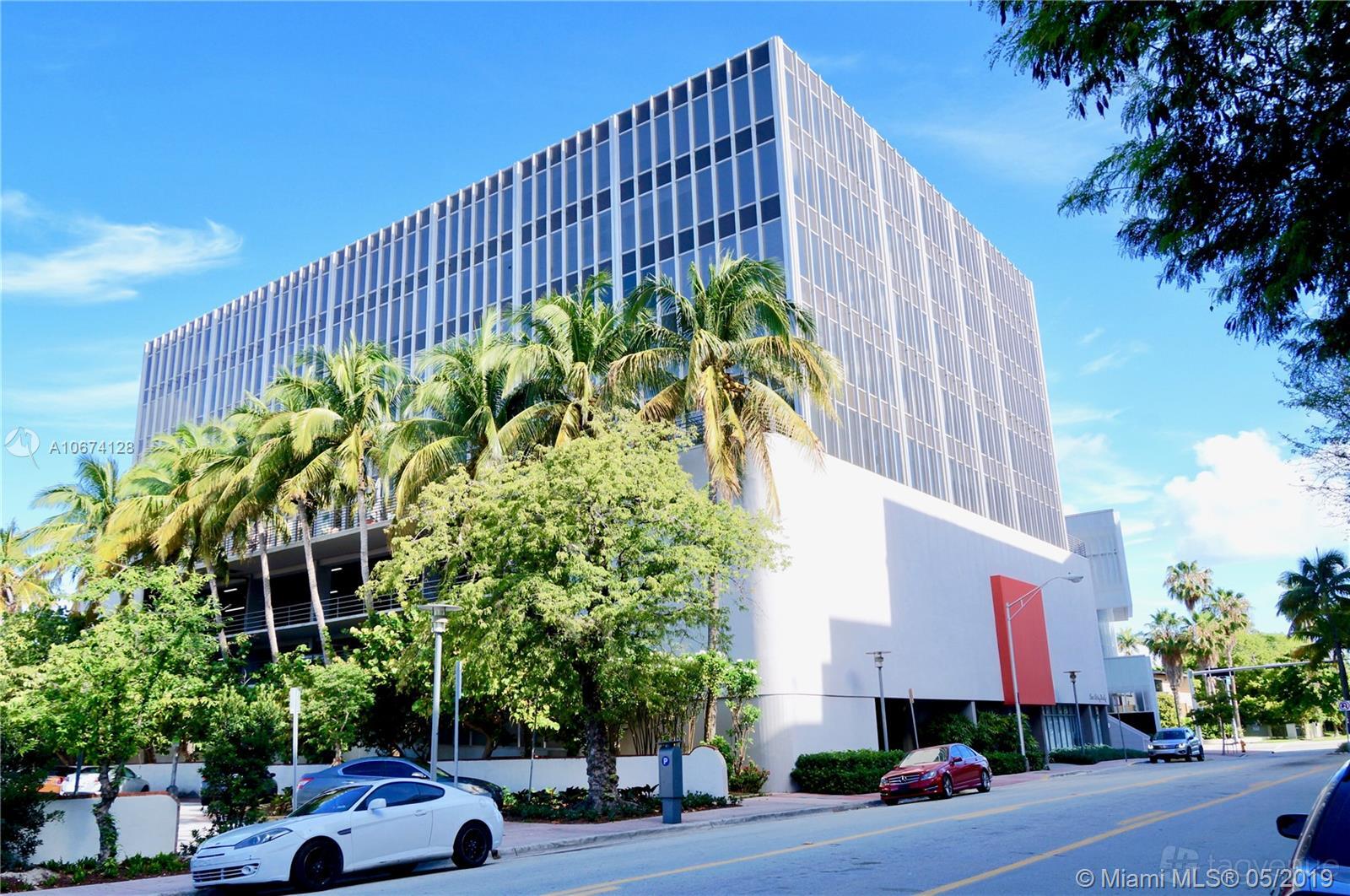 A conference centre with a modern glass façade, palm trees, and a street entrance at Momentum Business Center.