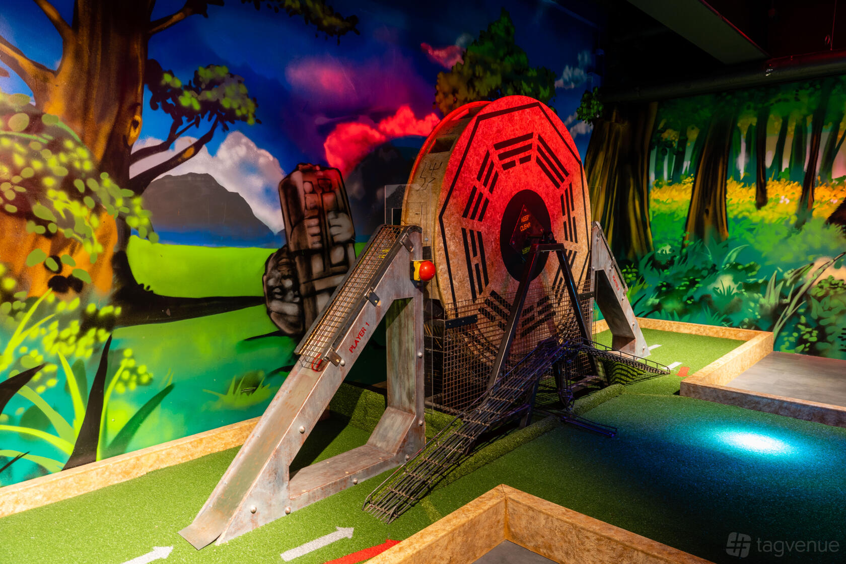 An indoor mini golf area with vibrant jungle murals and a large themed obstacle at The Light Banbury.