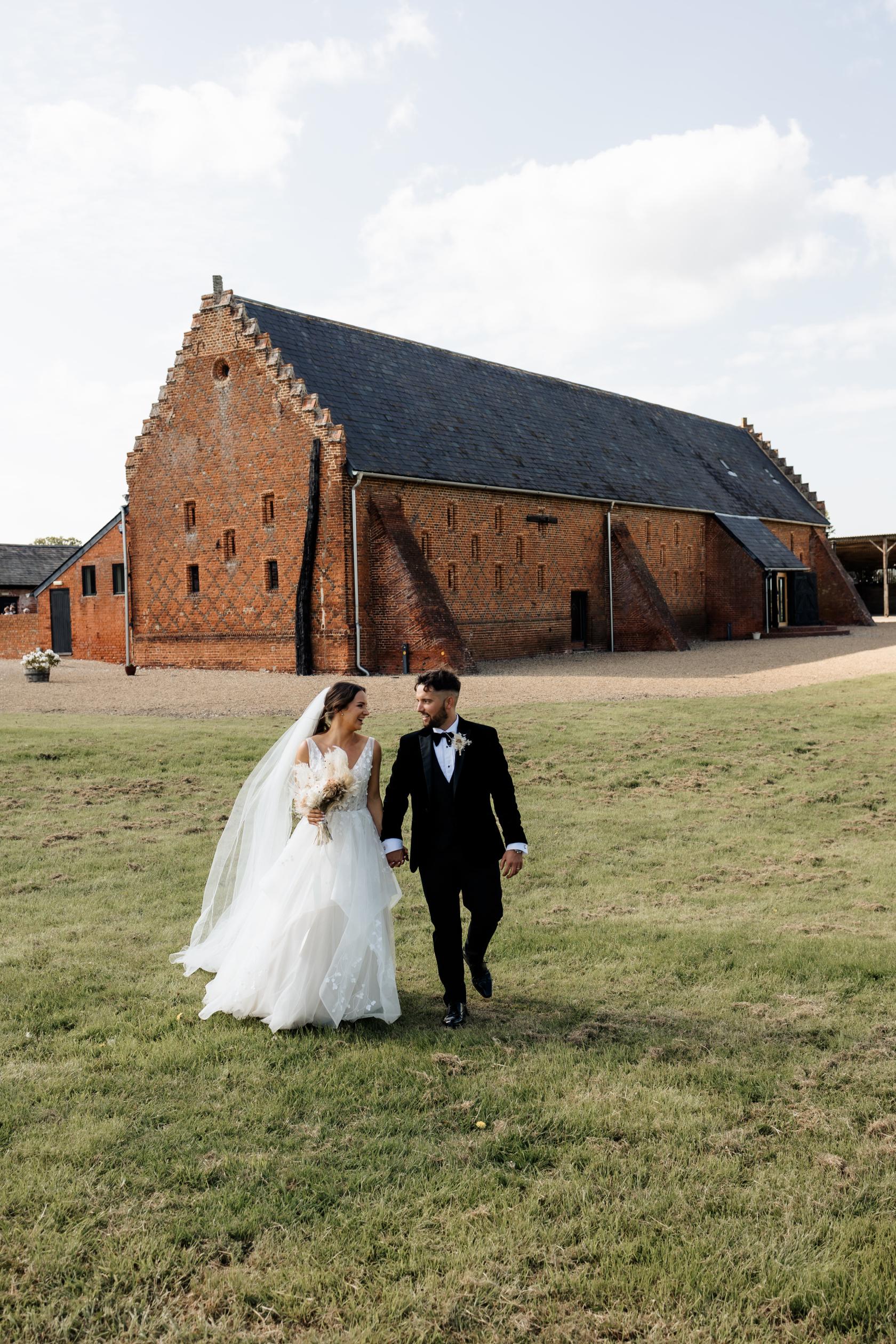 A historic hall with red brick exterior and pitched slate roof at Copdock Hall