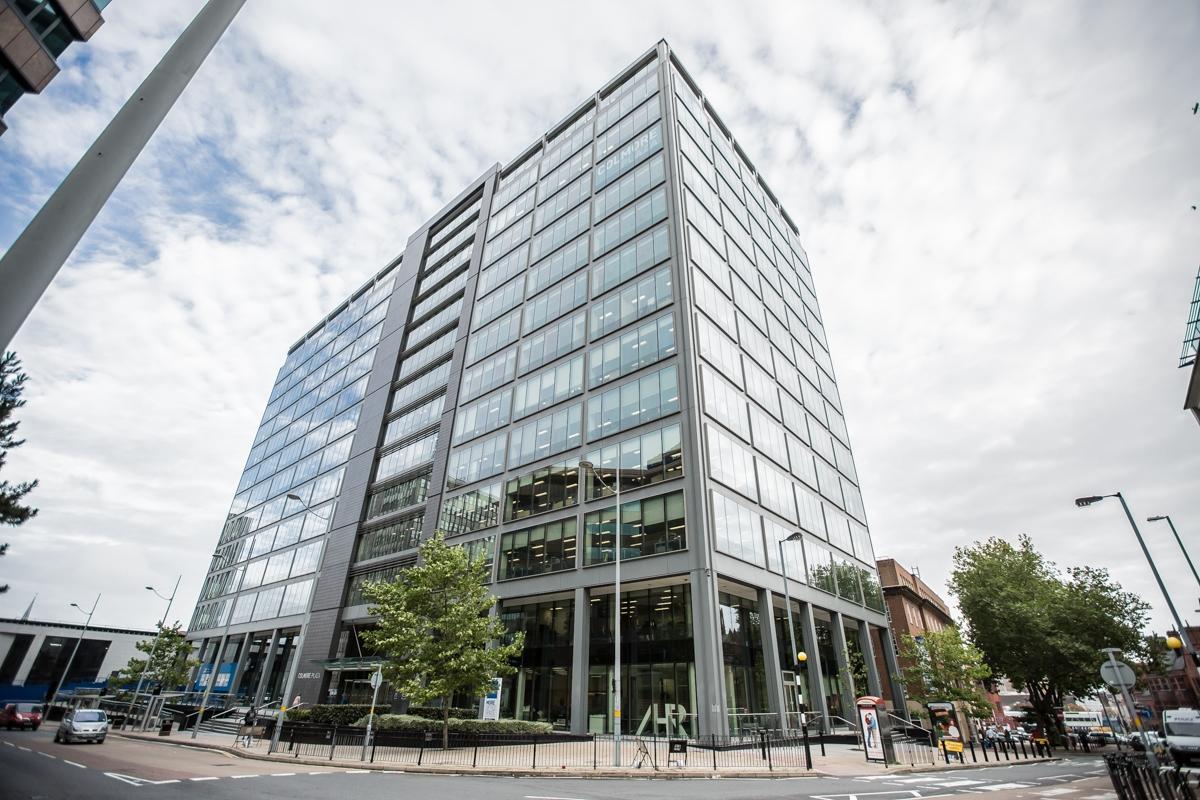 A meeting centre in a modern glass-fronted office building with multiple stories at Orega Birmingham - The Colmore Building.