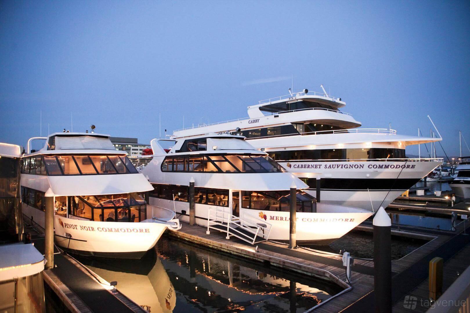 A yacht with multiple decks, large windows, and dockside views at Cabernet Sauvignon Yacht.