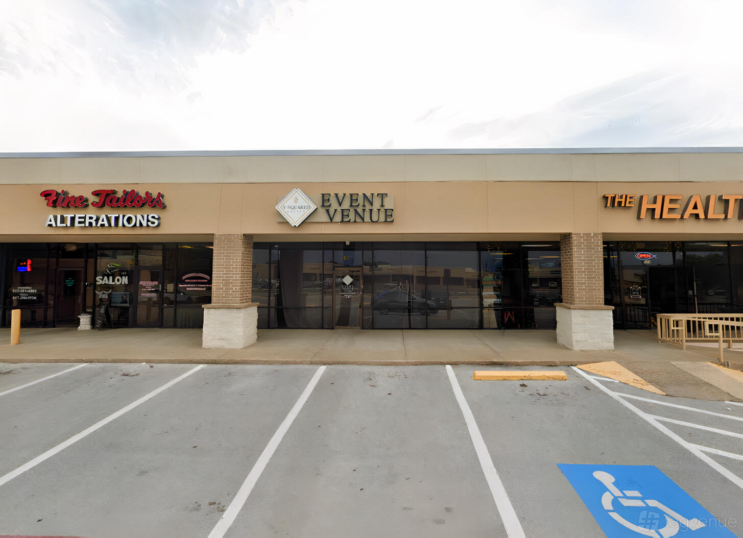 A hall with a glass-front entrance and a sign reading 'Event Venue' at Y-Squared Event Venue.