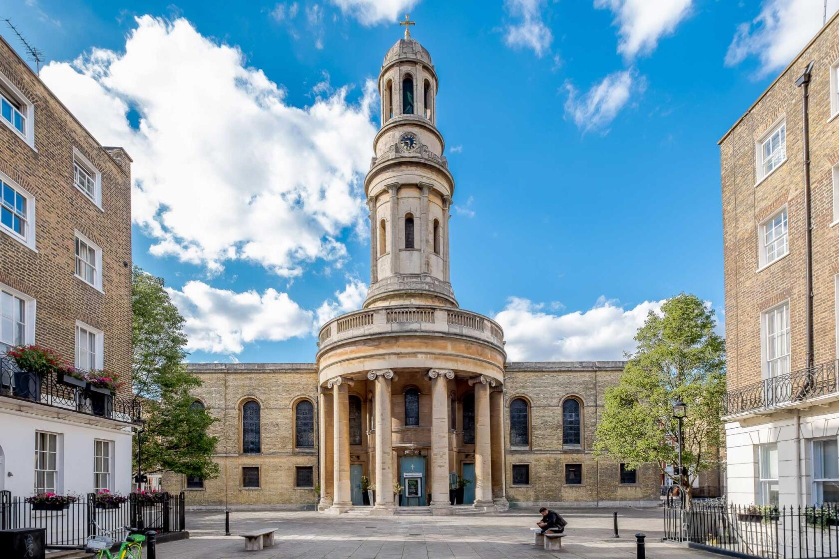 A historic church with a tall central tower, large columns, and arched windows at St Mary's London.