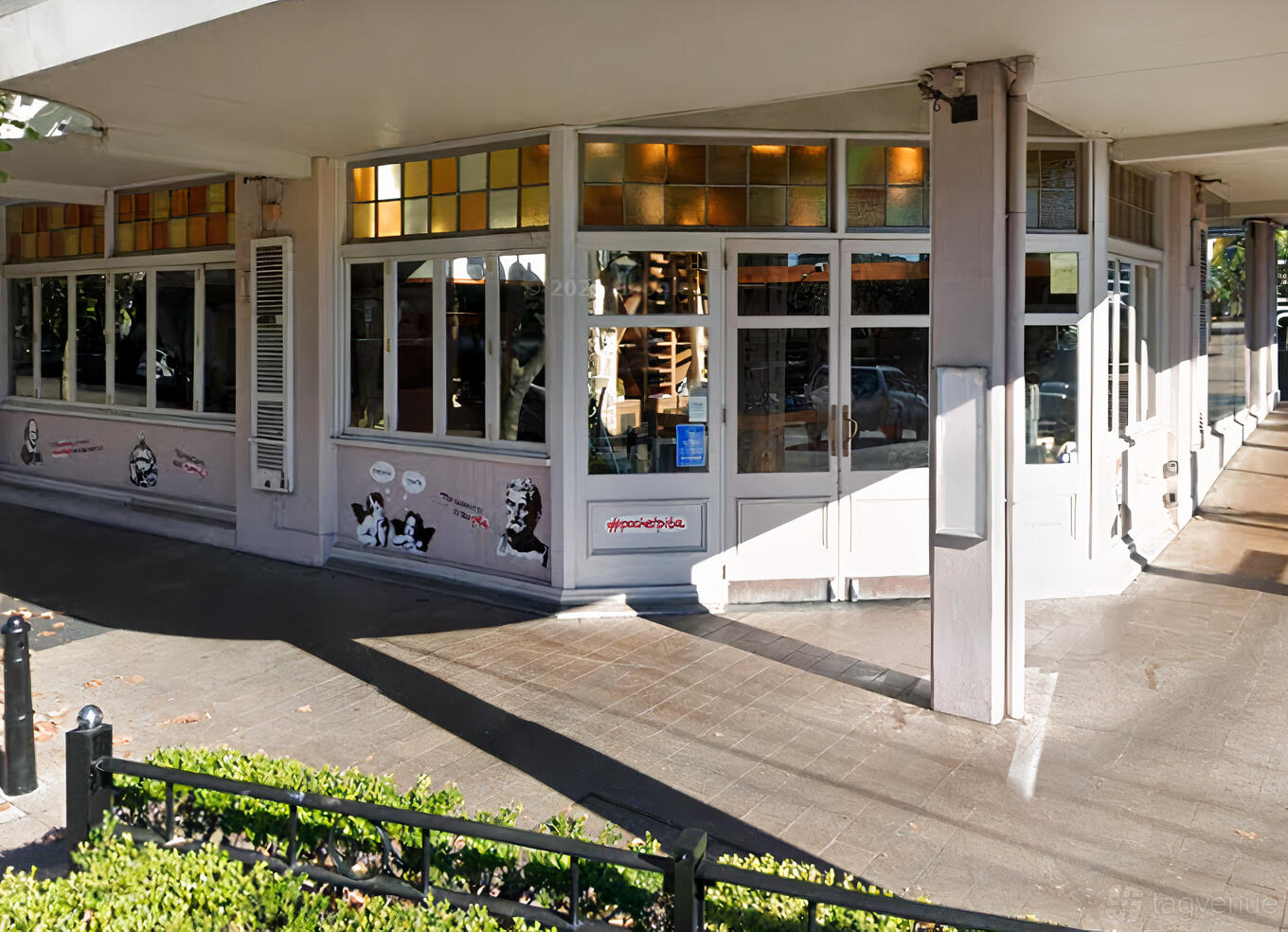 A restaurant with floor-to-ceiling windows and colorful stained glass above the entrance at El Guapo Cantina Bathurst.