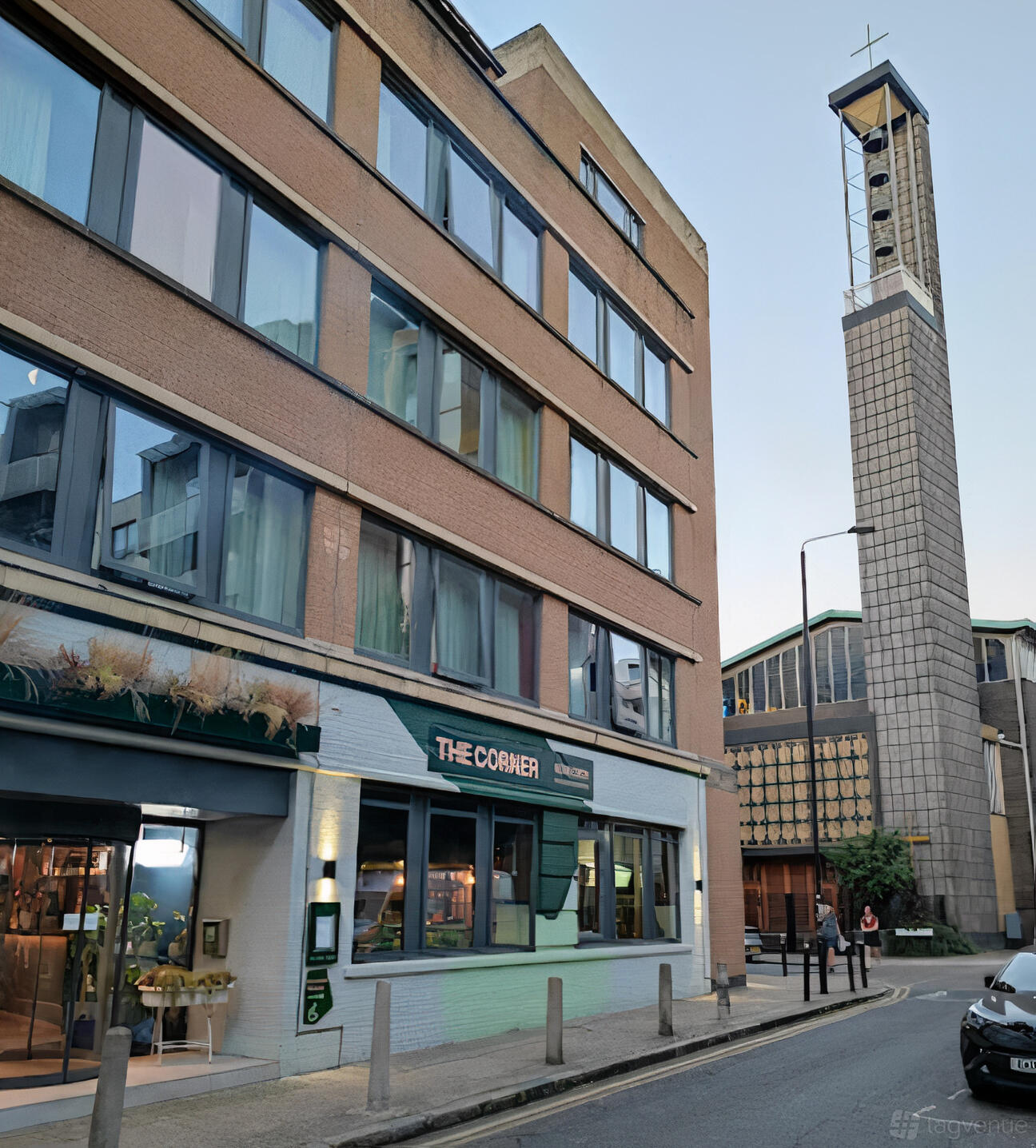 A hotel exterior with large windows and a ground-floor entrance at The Corner London City.