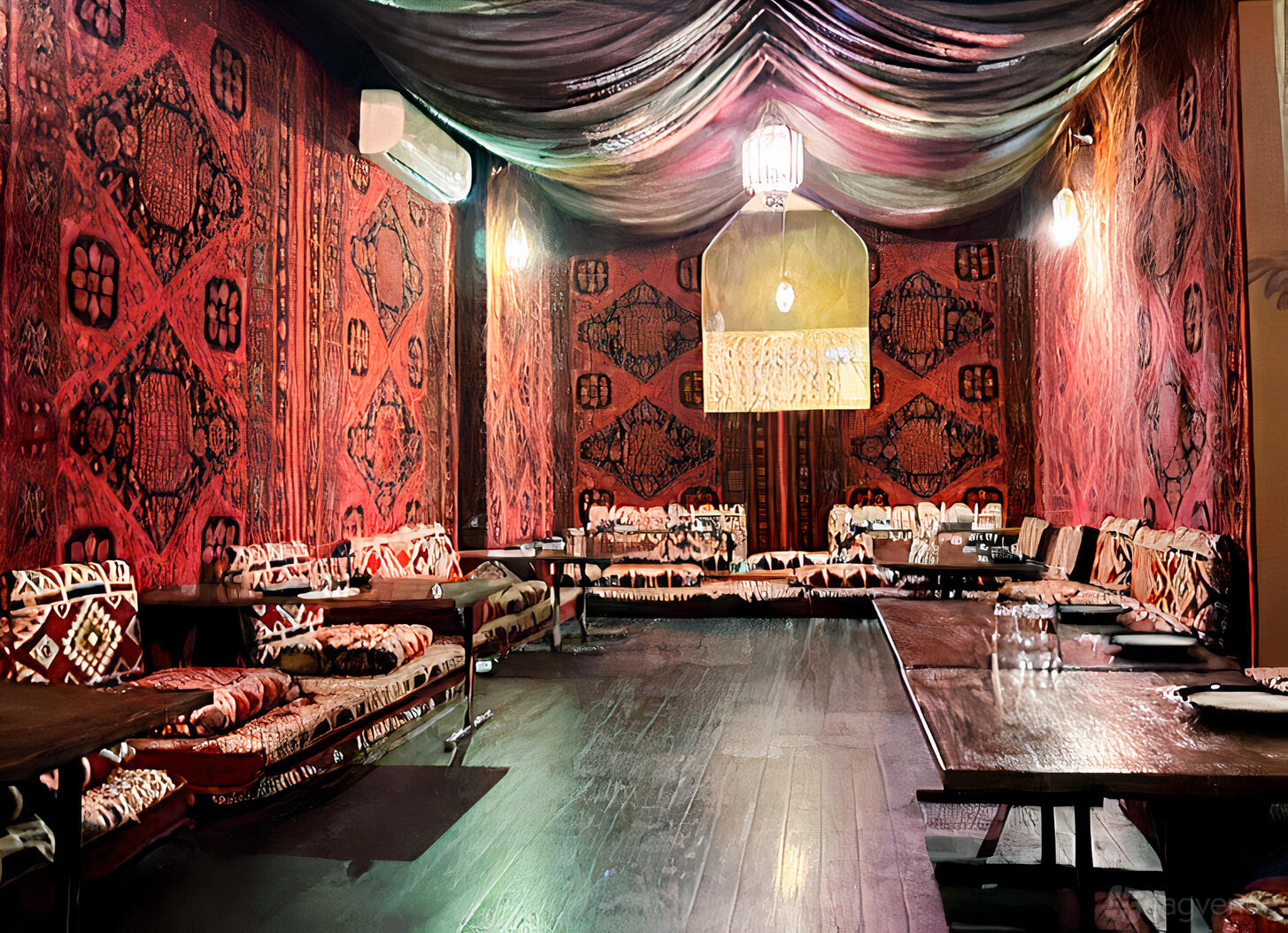 A dining room with low wooden tables, patterned floor cushions, and red tapestry walls at Hannibal Lebanese Restaurant.