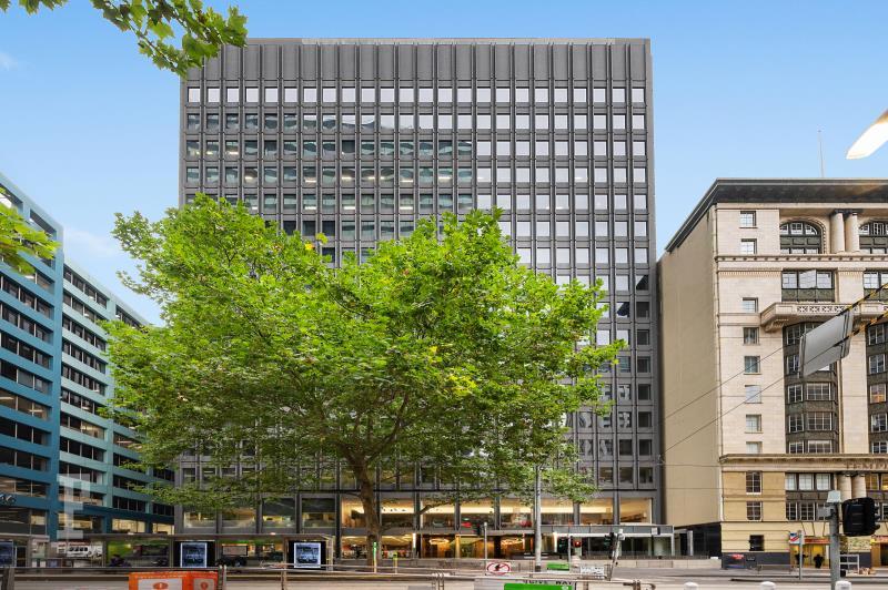 A multi-story conference centre with a glass façade and mature trees at the entrance at Cliftons Melbourne - Collins St.