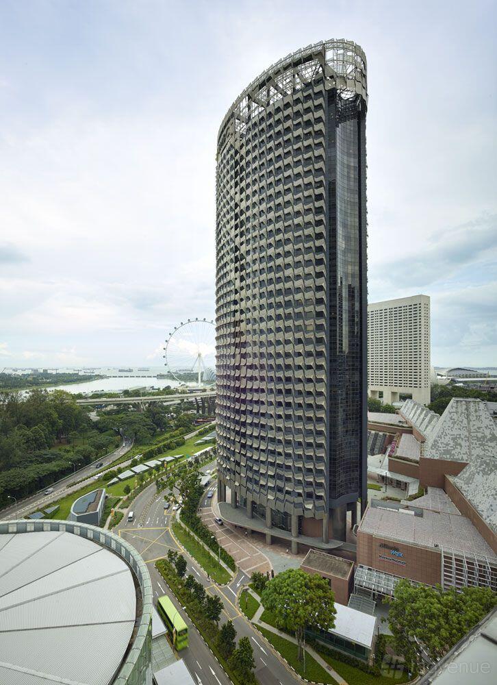 A meeting centre with a high-rise glass facade overlooking a cityscape and waterfront at The Great Room - Centennial Tower.