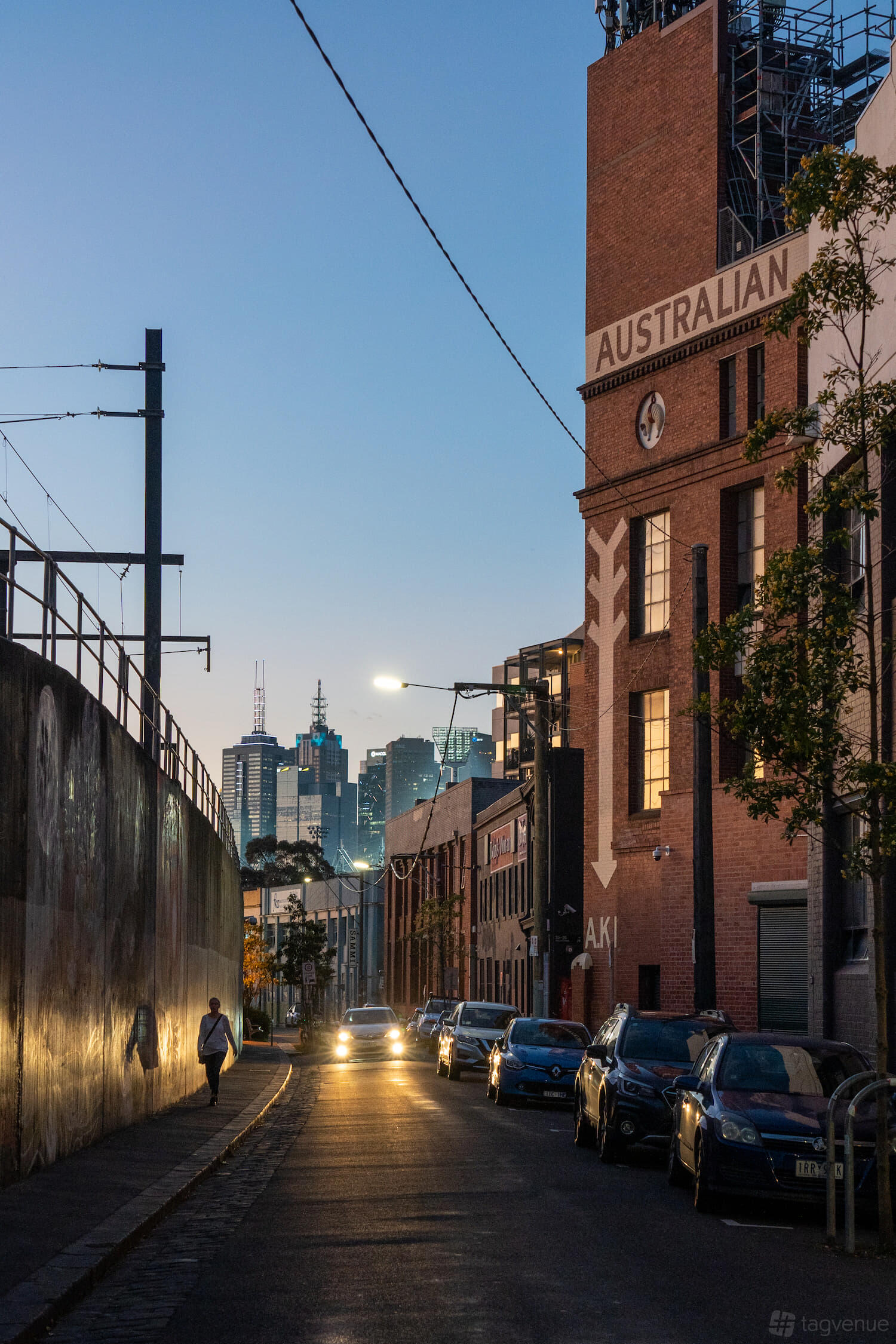 A coworking space in a red brick building with an exterior clock and city skyline views at Inspire9.