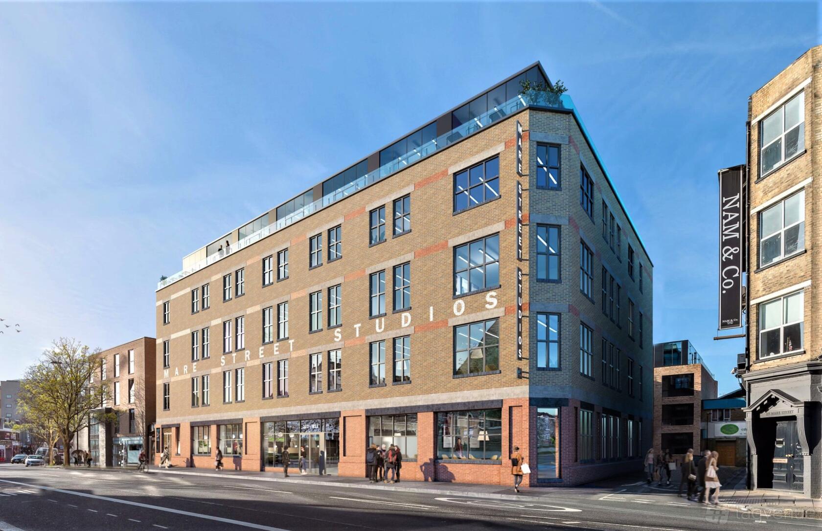 A recording studio building with large grid windows and rooftop terrace at iD Studios.