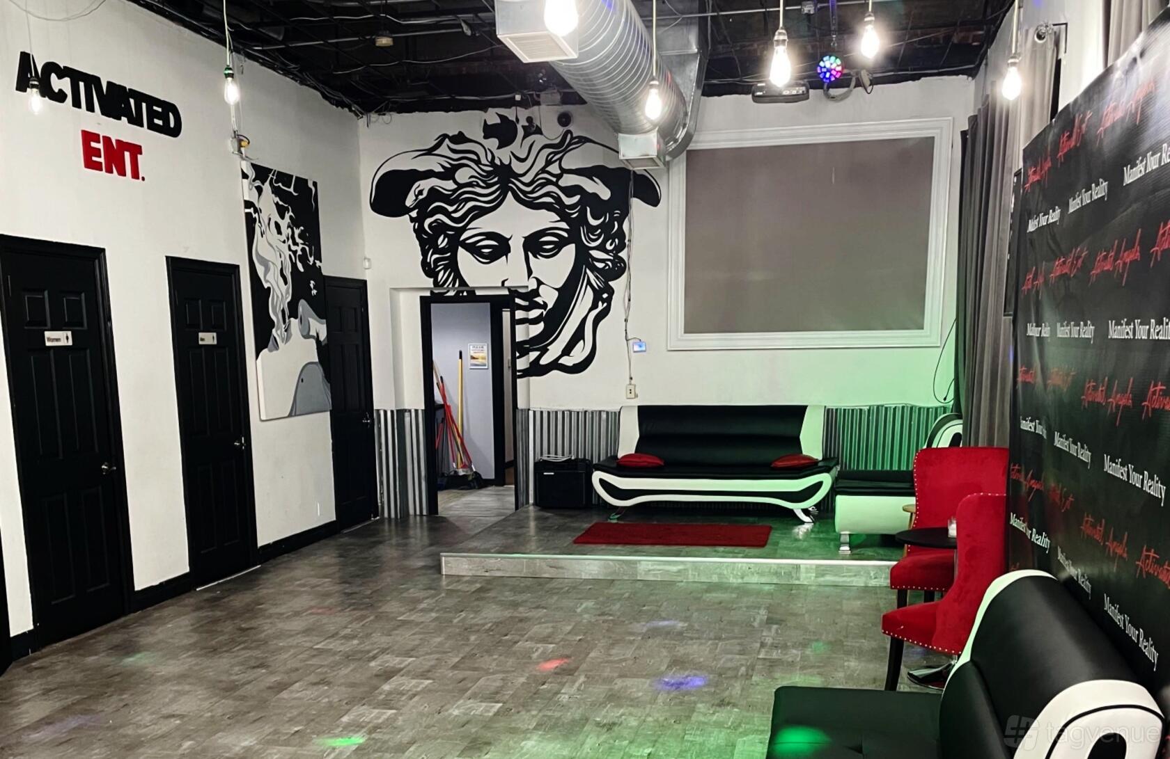 An event venue with wall art, lounge seating, and exposed ductwork at Activated Studios.