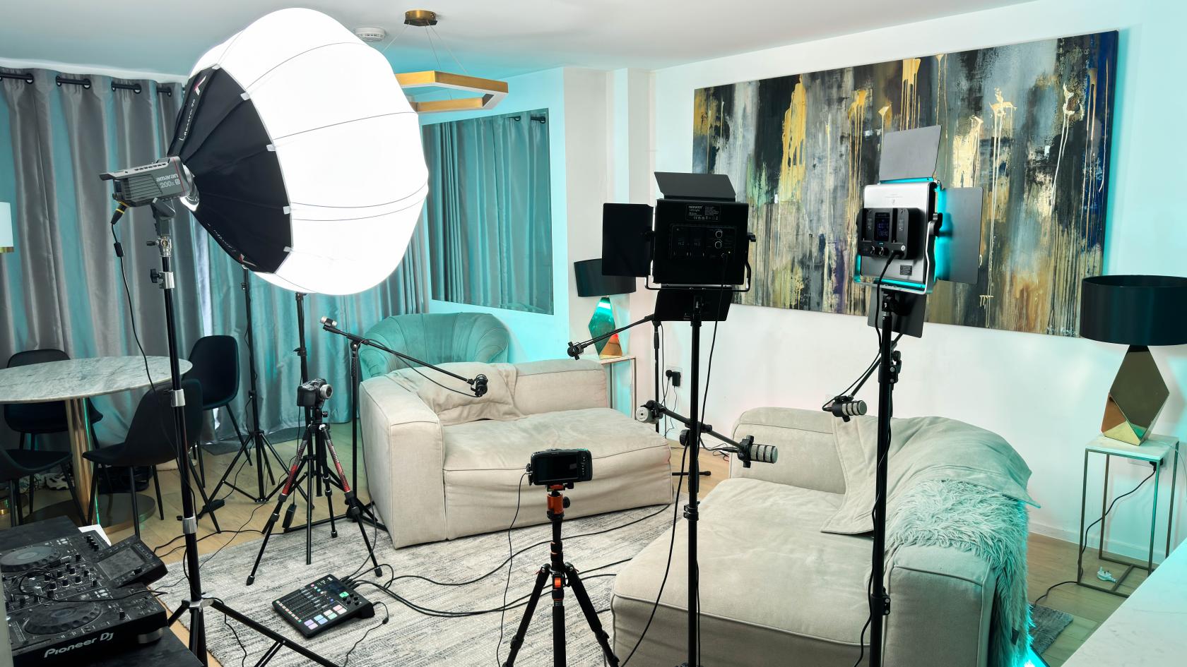 A podcast studio with two sofas, professional lighting, microphones, and recording equipment at Modern Podcast Studio.