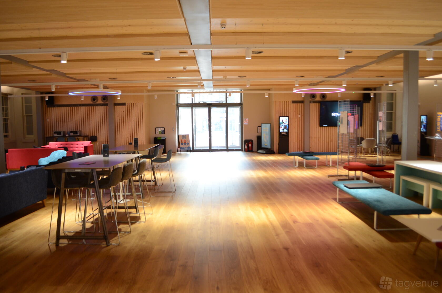 An open atrium event space with wood flooring, modern seating, and natural lighting at Dreadnought Building.