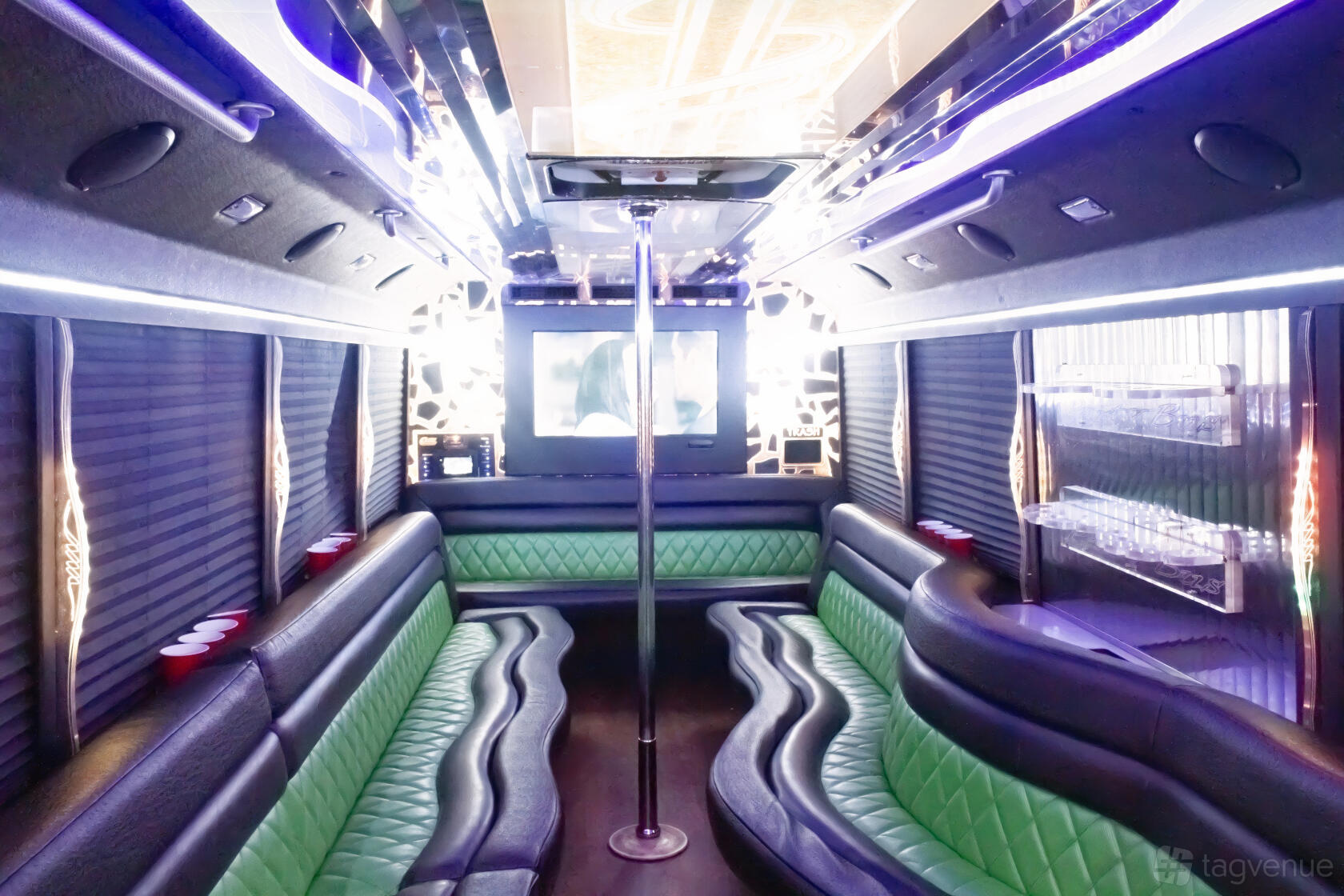 A party bus with green leather seating, mirrored ceiling, and LED lighting at GOGO Party Bus.