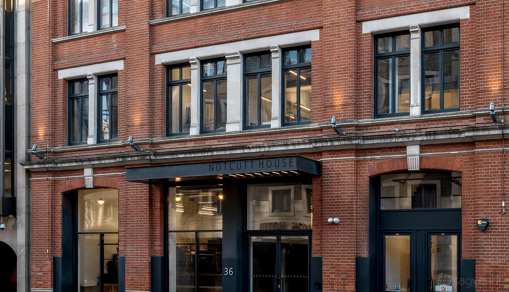 A meeting centre with a red brick façade and large black-framed windows at Notcutt House.