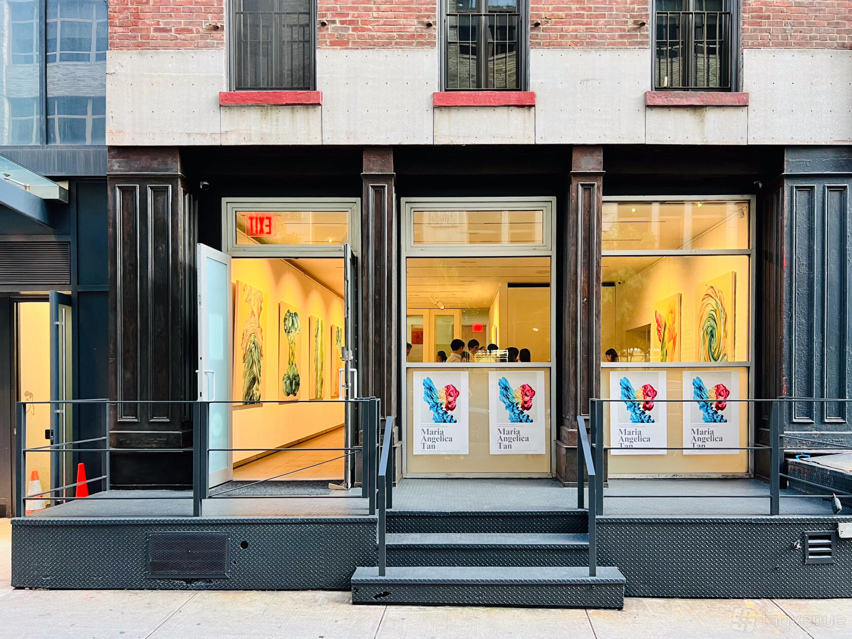 A blank canvas venue with floor-to-ceiling windows, white walls, and contemporary artwork at Contemporary Minimal Soho Venue.