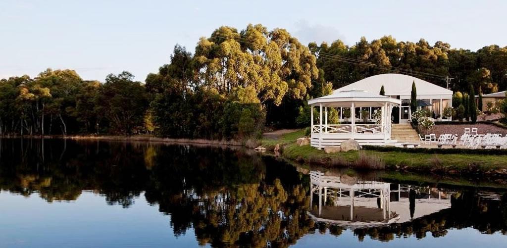 A conference centre with a lakeside gazebo, surrounded by trees and water at Cammeray Waters Function Centre.