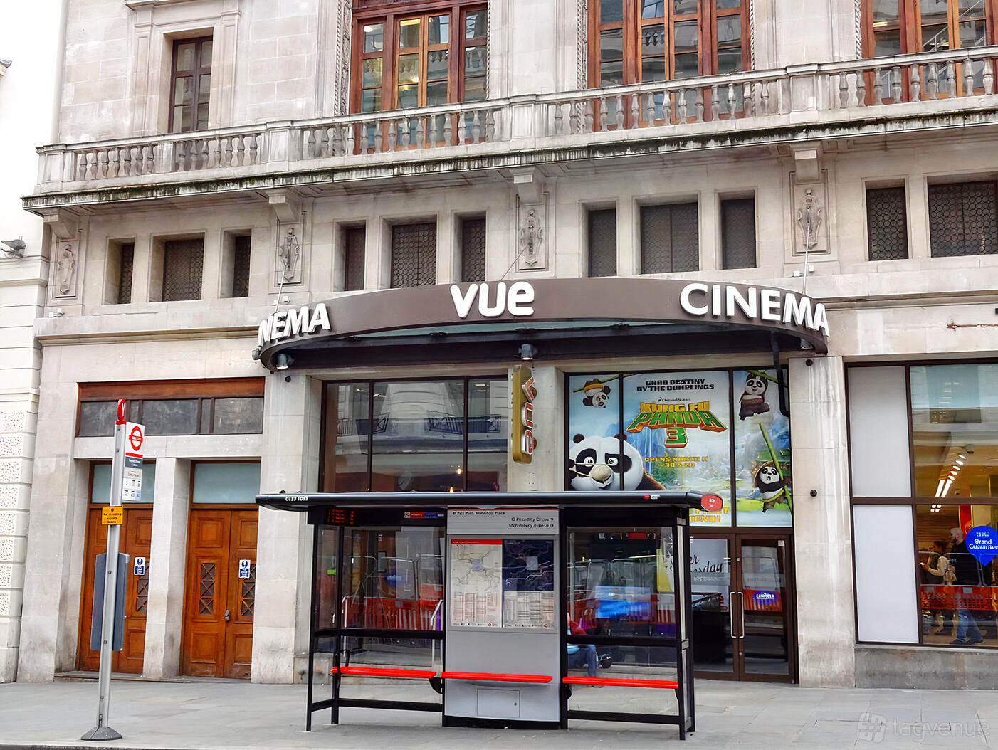 A cinema exterior with large arched windows, marquee signage, and movie posters at Vue Piccadilly.