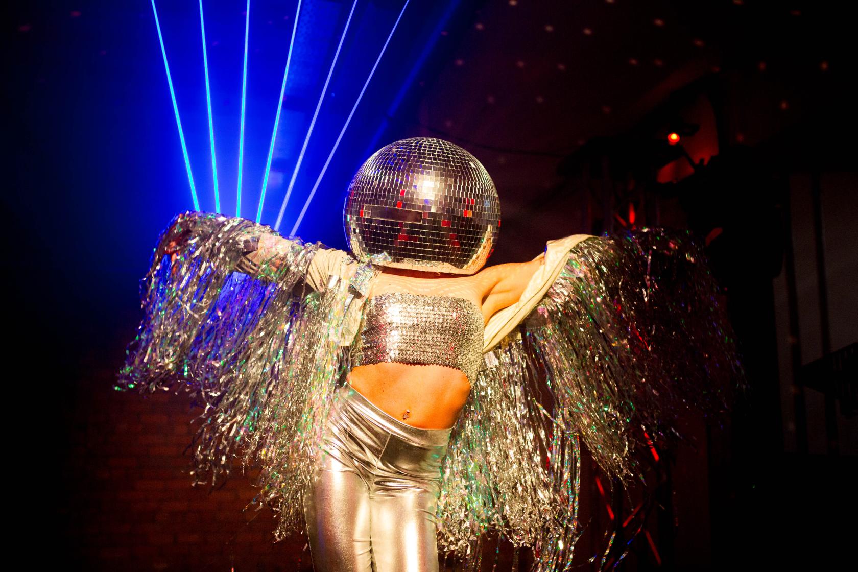 An event space in a warehouse with exposed brick walls and colorful stage lighting at Victoria Warehouse.