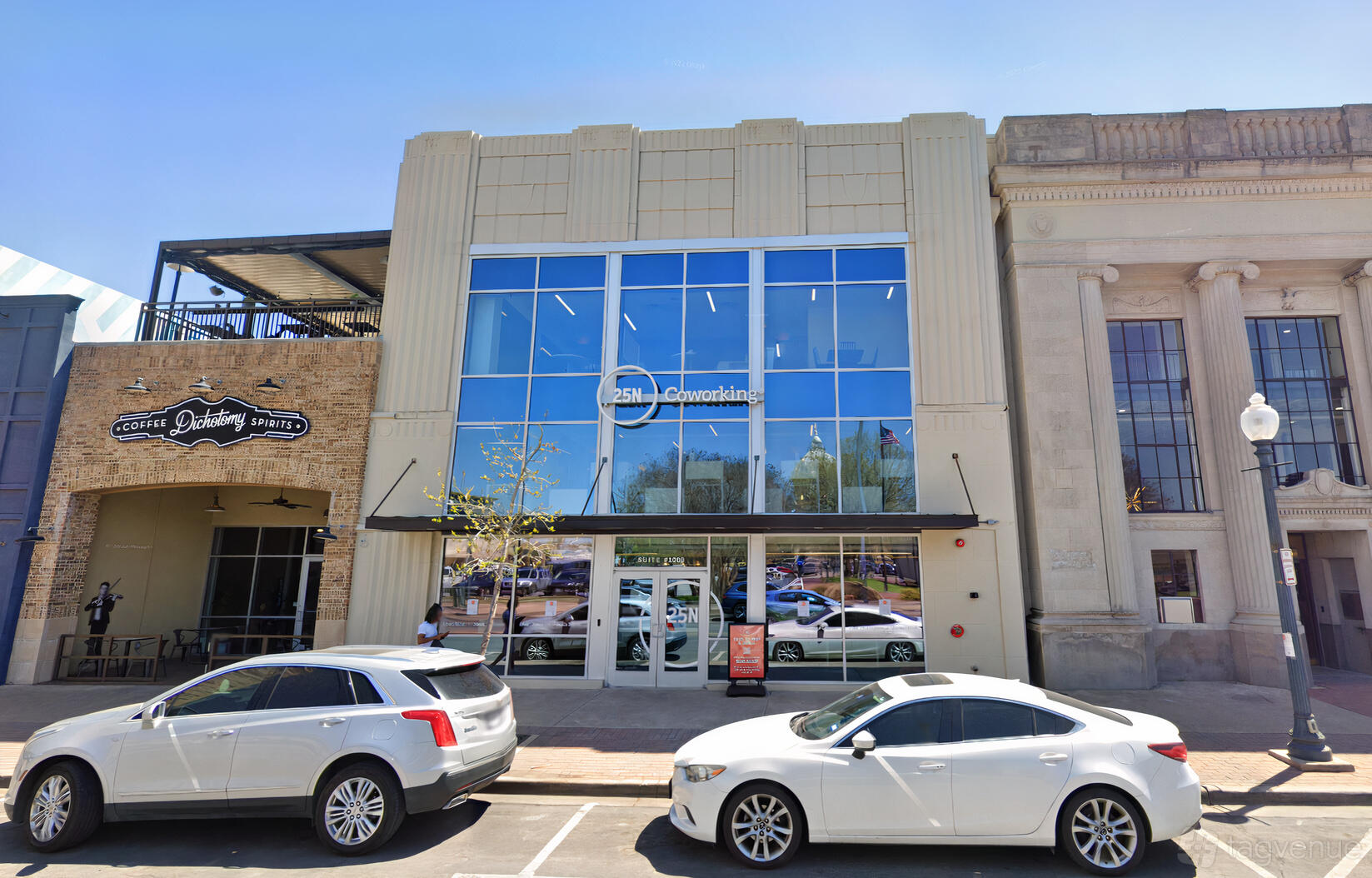 A coworking space with a glass façade, tall windows, and street-facing entrance at 25N Coworking Waco.