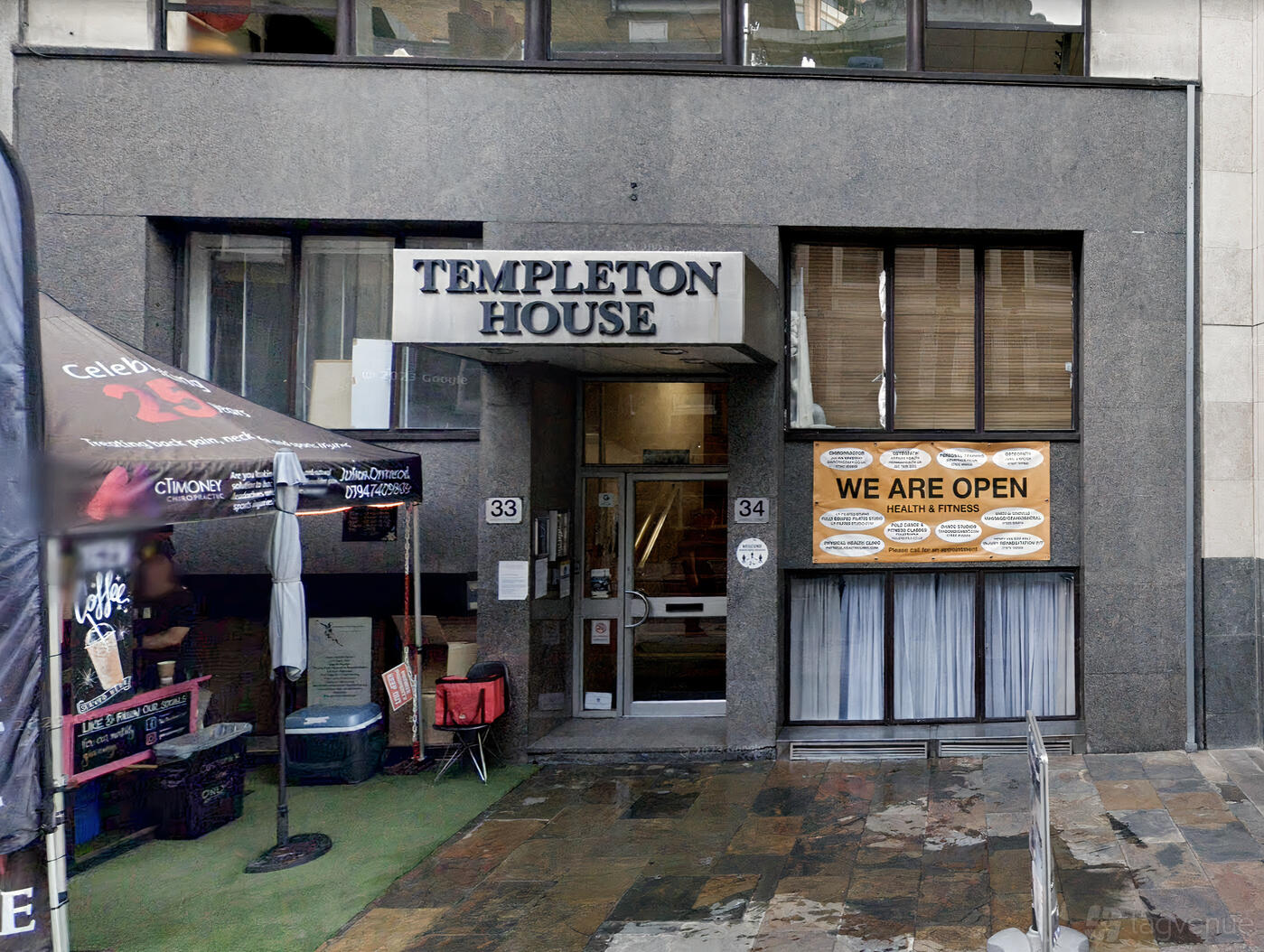 A dance studio entrance with a glass door and signage at Studio Movement.