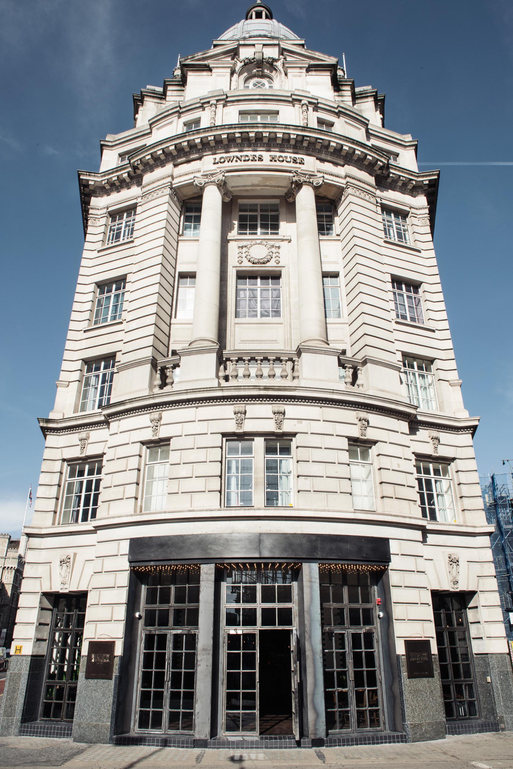A historic stone building with large arched windows and classical columns at Singer Tavern.