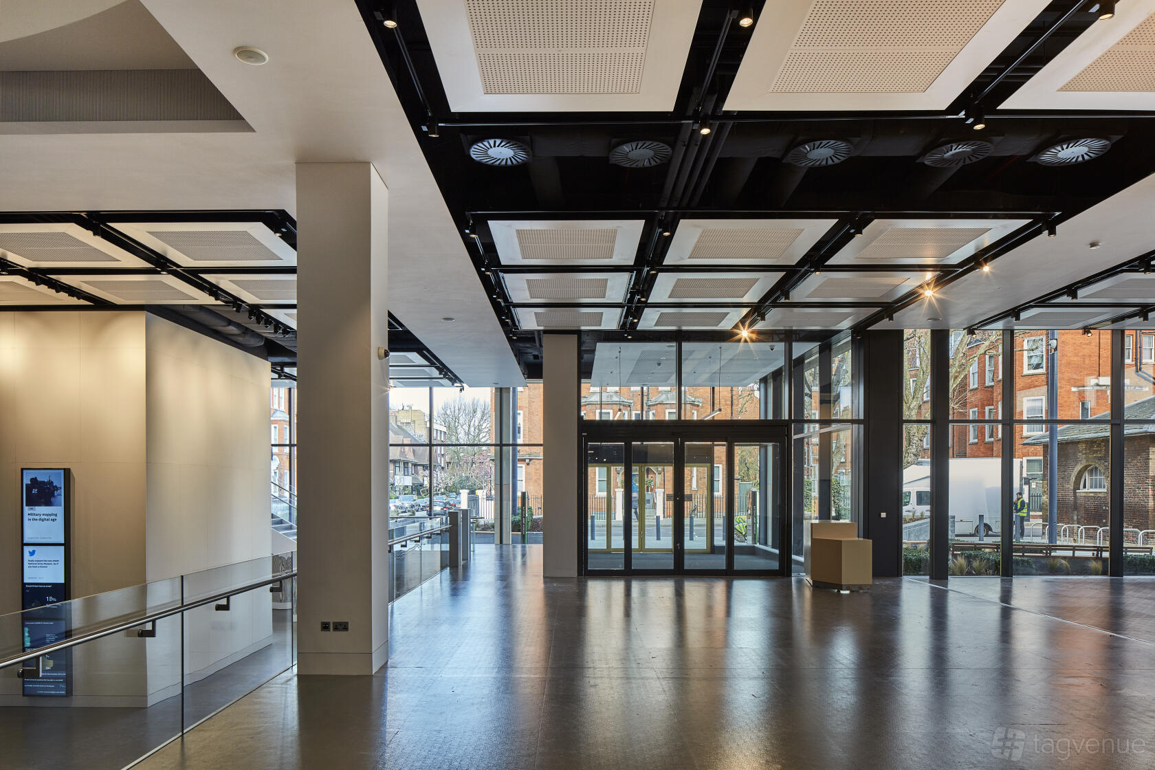 An event space with floor-to-ceiling windows, exposed ceiling panels, and polished flooring at National Army Museum.