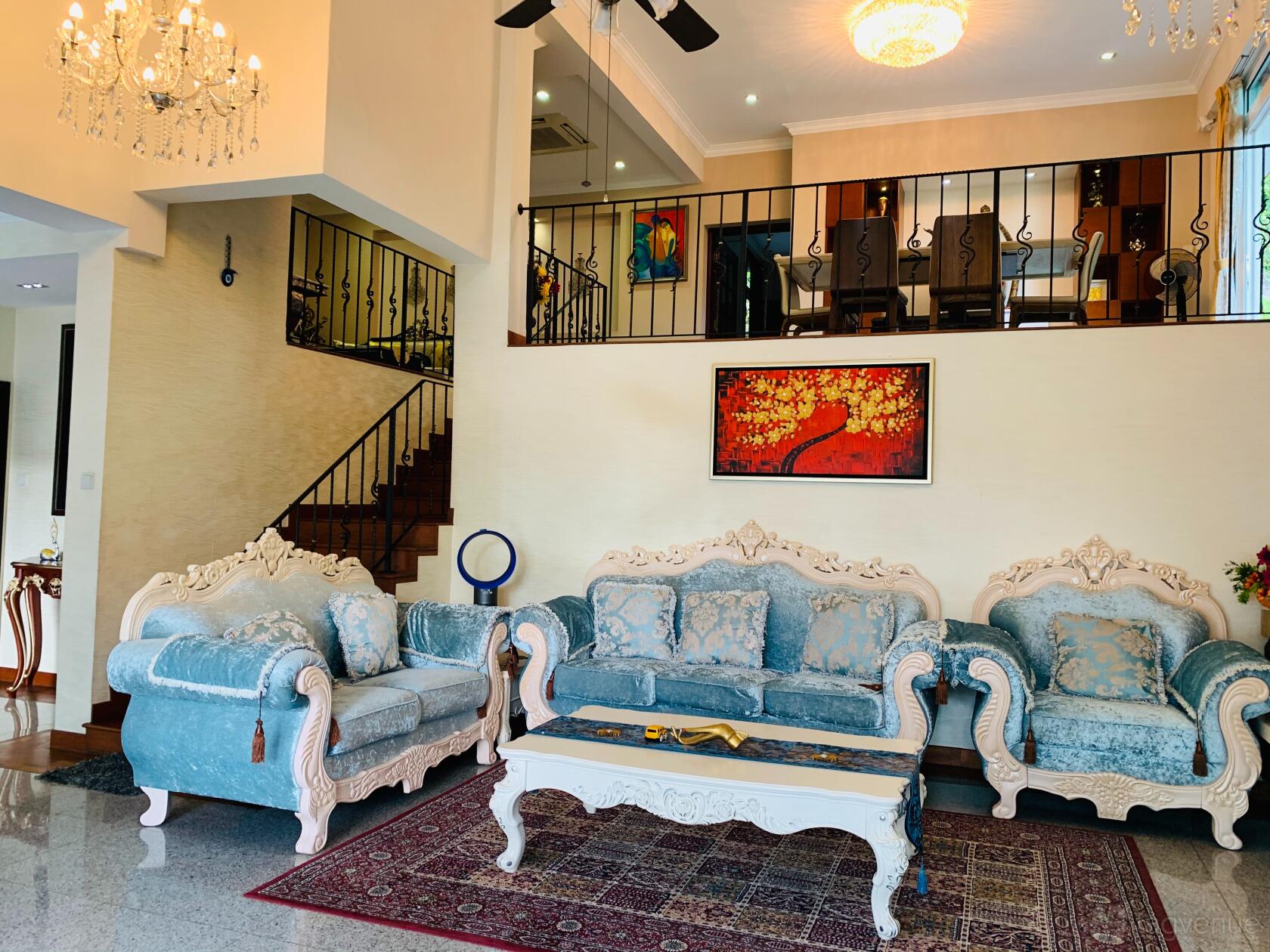 A living room in a house with ornate blue sofas, a chandelier, and a staircase at Bungalow/Landed Property.