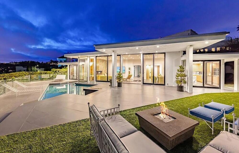 An apartment with a patio, pool, and outdoor fire pit seating at Beautiful Villa with Downtown Views.