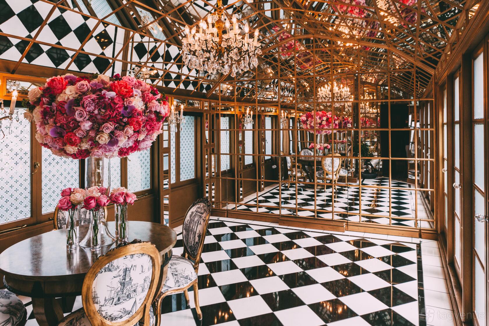 A dining room with mirrored walls, chandeliers, and black-and-white checkered flooring at 11 Cadogan Gardens.