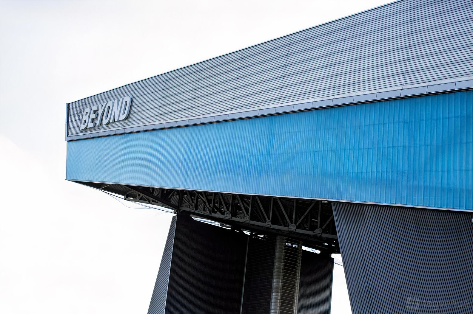An exterior view of a modern building with blue paneling and the 'BEYOND' sign at Chill Factore.