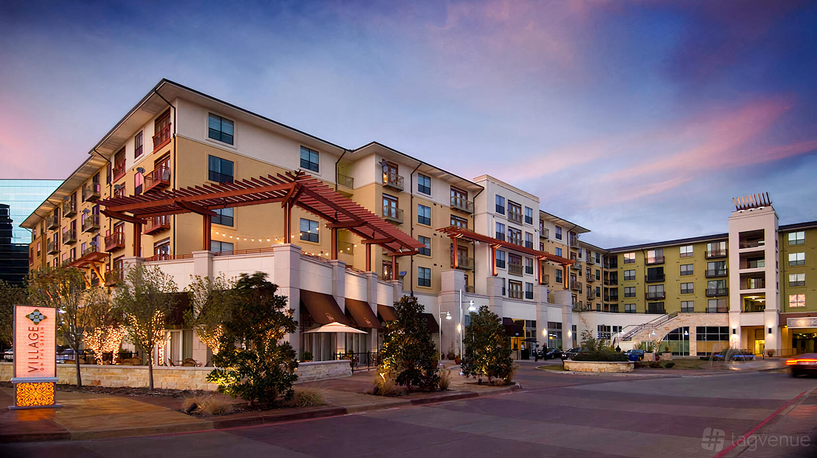 A meeting centre with a multi-story facade, large windows, and outdoor landscaping at Venture X | Dallas by the Galleria.