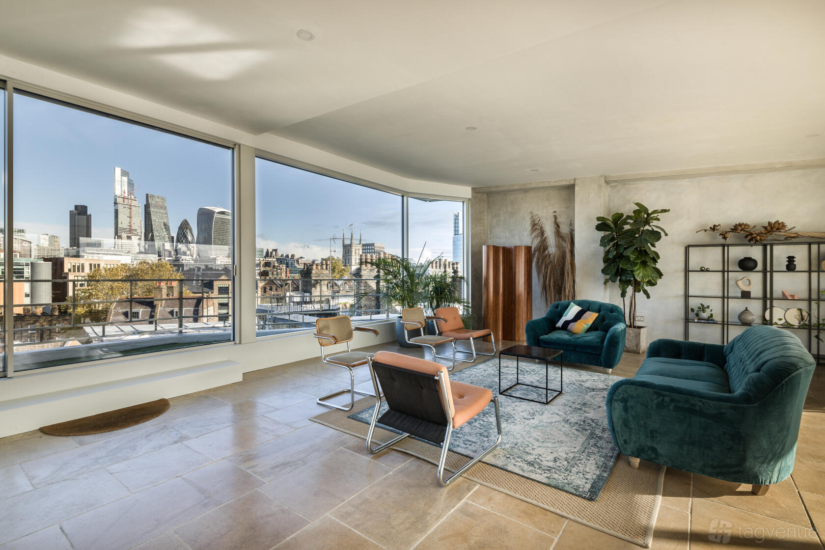 A loft with floor-to-ceiling windows, city skyline views, modern lounge seating, and open shelving at Last-min Space with City View.
