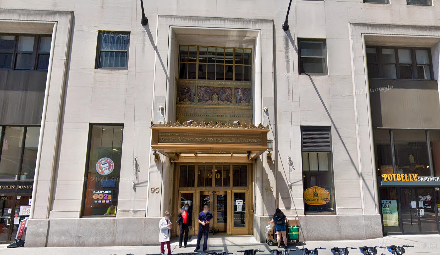 An office building entrance with gold accents, large windows, and art deco details at Select Office Suites FiDi.