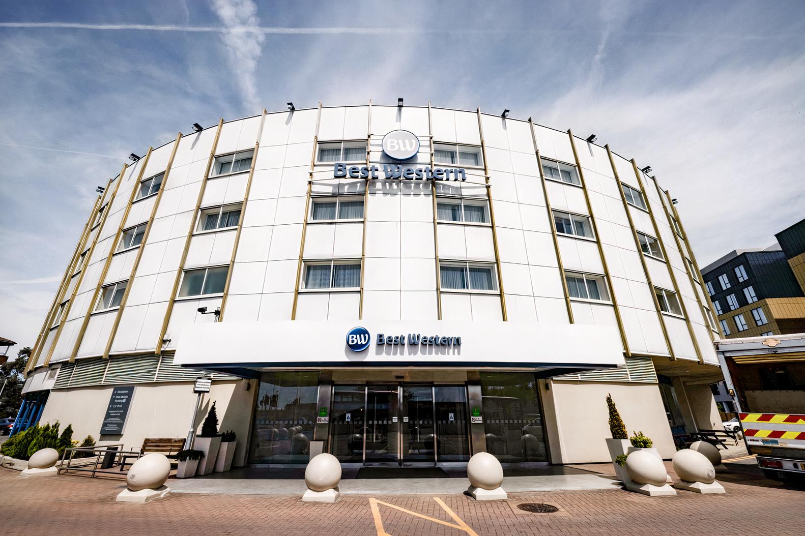 A hotel exterior with a rounded white facade, large windows, and Best Western signage at Best Western Ariel London Heathrow.