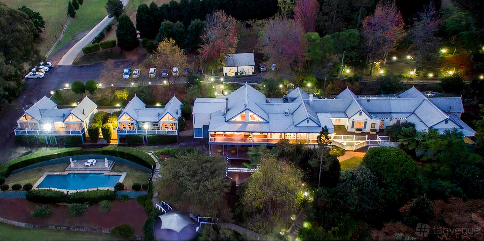 A versatile event space with white-roofed pavilions, a landscaped garden, and a swimming pool at Loxley on Bellbird Hill.