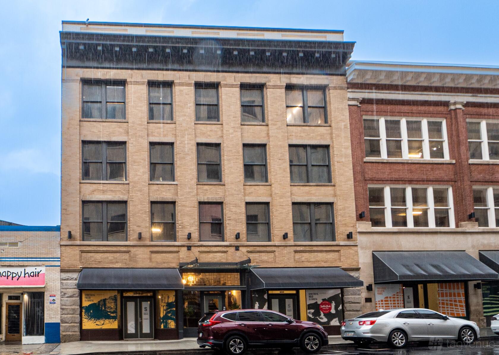 A meeting centre with a brick facade, tall windows, and black awnings at Ohio River South.