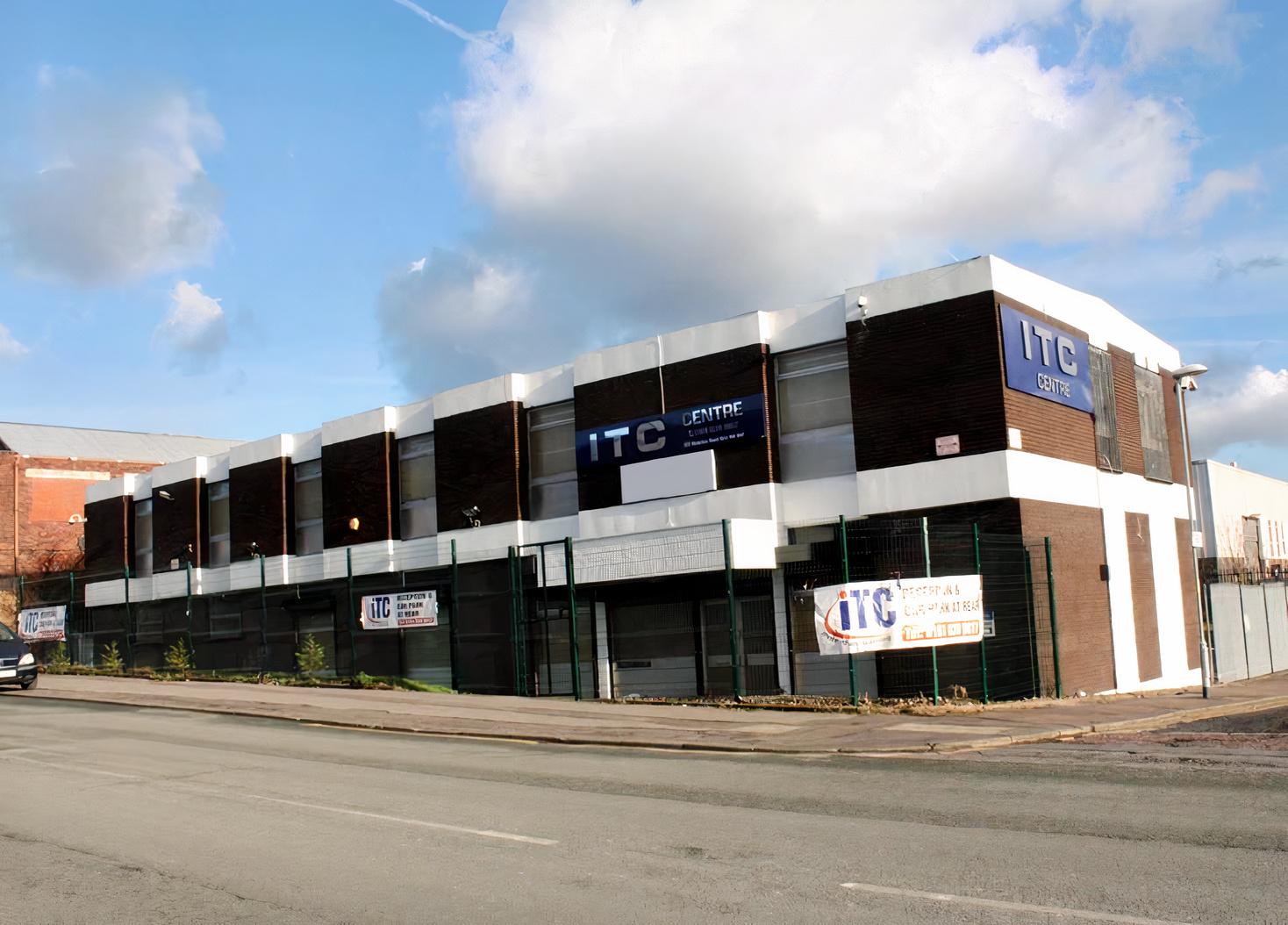 A conference centre with a modern two-story facade, large windows, and ITC Centre signage.