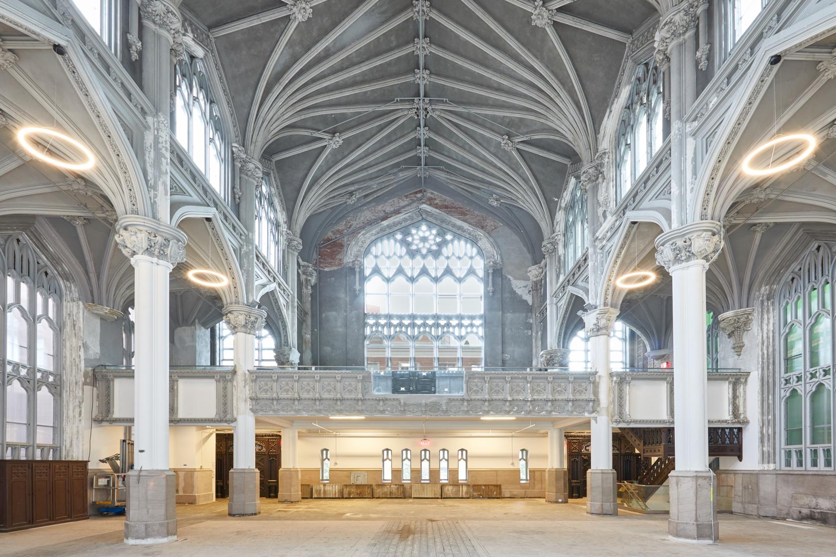 An event venue with vaulted gothic ceilings, arched windows, and grand columns at Harlem Parish.