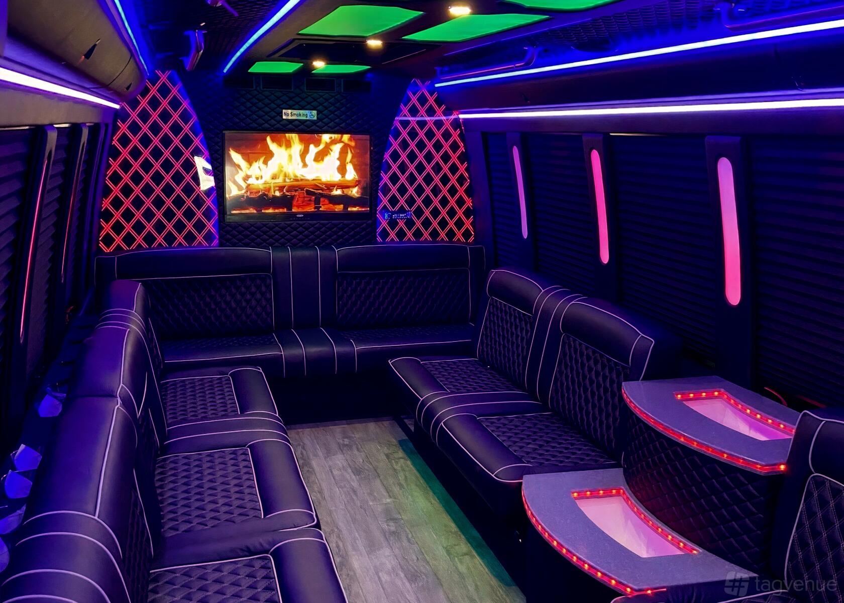 A party bus with wraparound leather seating, LED strip lighting, and a fireplace screen at GOGO Party Bus.
