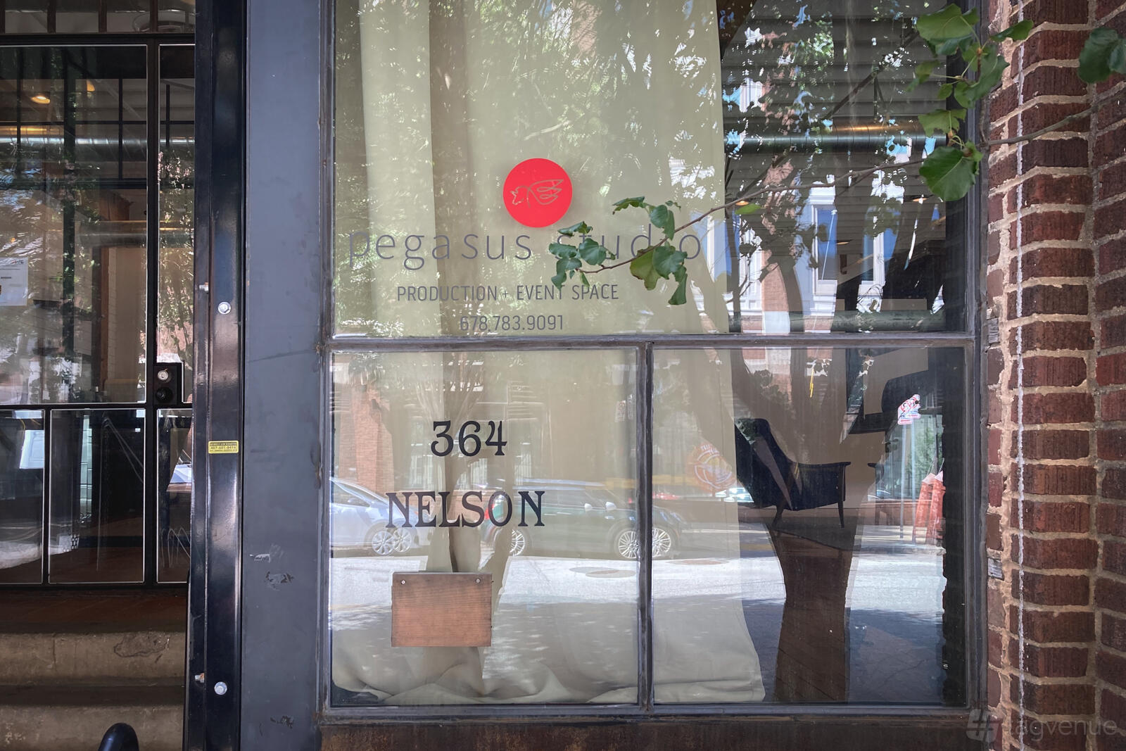 A film and photo studio with large front windows, exposed brick exterior, and visible signage at Pegasus Studio.