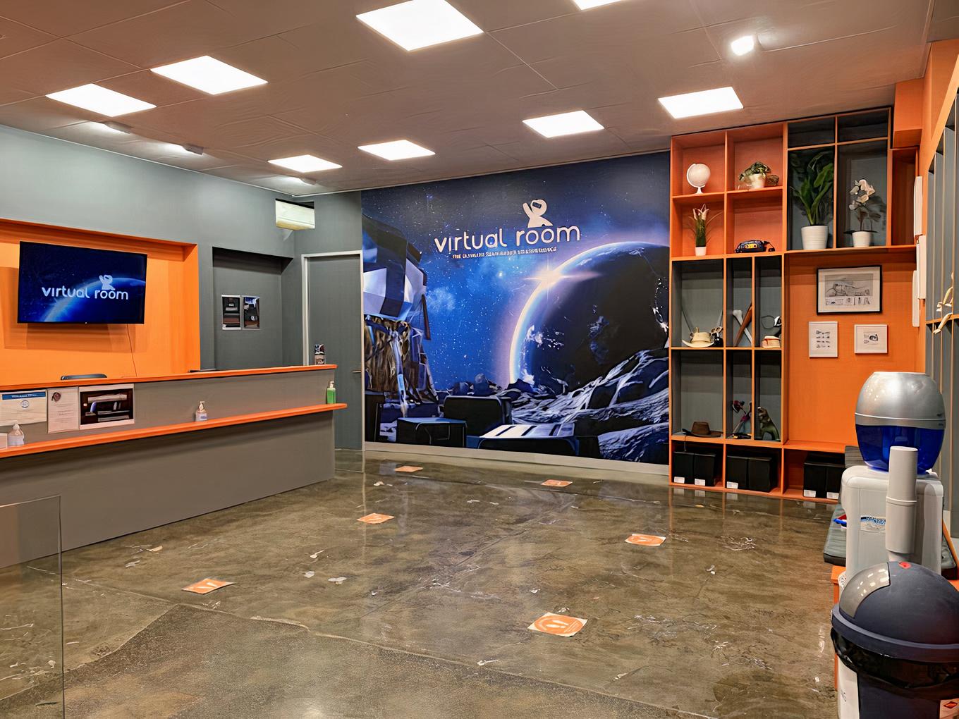 An event venue with polished concrete floors, a reception desk, and a space-themed mural at Virtual Room: Virtual Reality Melbourne.
