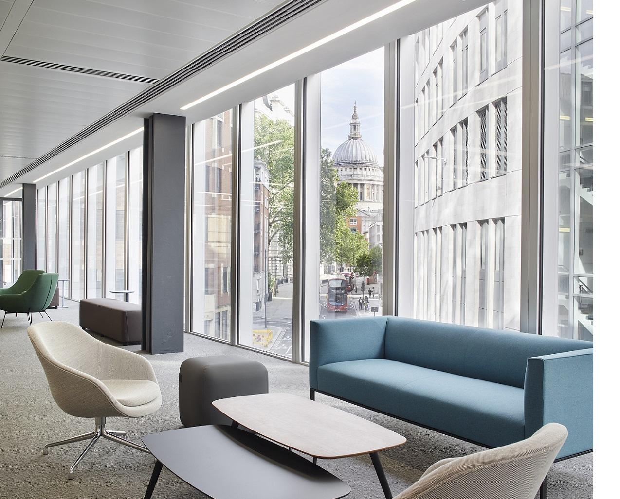A lounge with floor-to-ceiling windows, contemporary seating, and views of St. Paul's Cathedral at London Conference Centre.