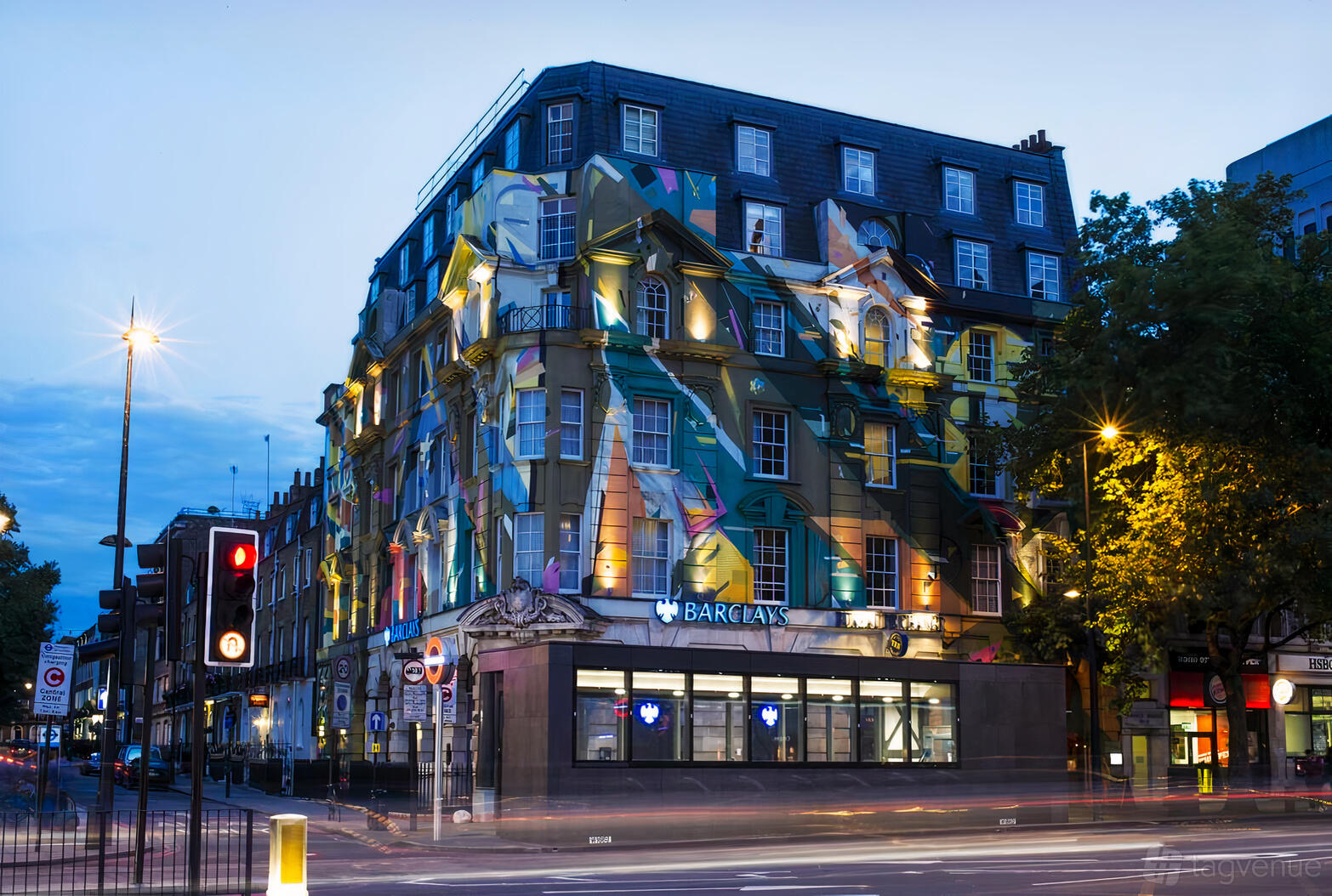 A hotel with a vibrant mural-covered facade and illuminated windows at The Megaro Hotel.